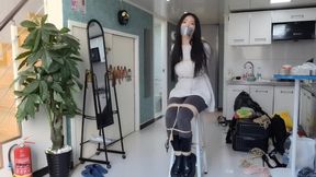 a chinese girl bound to a chair and duct tape gagged
