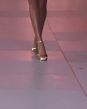 Fashion show model strides down runway