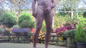 naked in garden having a pee