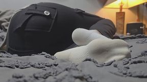 Chrissy napping socks on bed