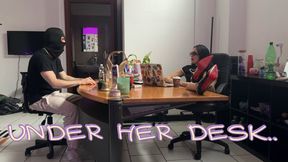 UNDER HER DESK..