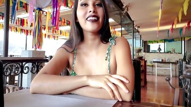 Young Mexican woman explores herself in green floral dress across terrace and couch
