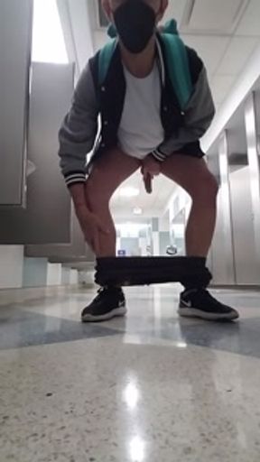 Jacking off and cumming with my pants down to my ankles at the Chicago airport bathroom
