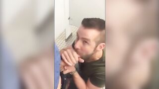 Handsome guy sucks dick in restroom stall