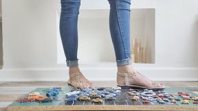 Priscilla toy car crush she crushes many tiny cars in flat sandals close ground view