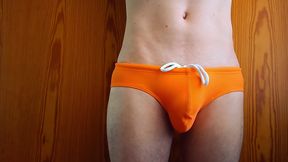 growing bulge in orange swim trunk - what every boy fears and girls dreaming of