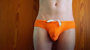 growing bulge in orange swim trunk - what every boy fears and girls dreaming of