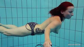 ”Redheaded Katrin is stripping underwater”