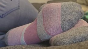 Chrissy laying on couch in puma socks pt4