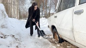 CAR STUCK Beautiful brunette slips her wheels in the snow