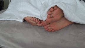 Intertwining toes under the blanket A a