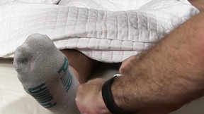 Hunky unshaved stud enjoys having his feet licked by mature gay