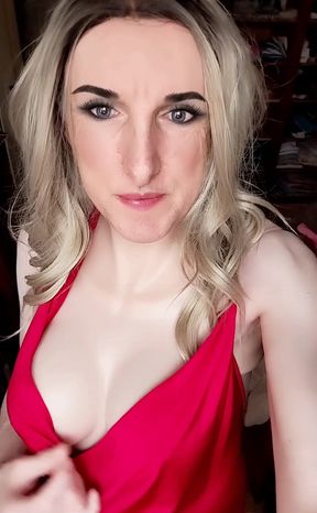 Cheryl Laroche in a mini-dress with a very deep neckline showing her big breasts nicely decorated with piercings.