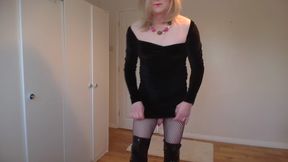 Blonde in a little black dress, boots and fishnets
