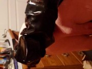 Slave plugged and in chastity, squirming and trying to escape the skintight rubber sleepsack