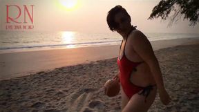 Nice lady at lonely nudist beach. Red swimsuit. Red bikini. Coconut