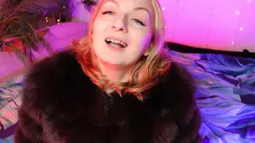 Domina with red lipstick and fur reigns over submissive under braces