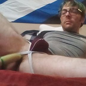 PupFritz plays with a wrapped sex toy in bedroom