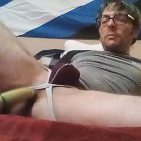 PupFritz plays with a wrapped sex toy in bedroom