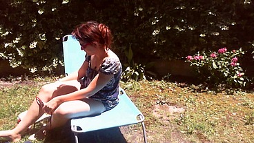 Italian girl sunbathing in a public garden with a big dirty diaper