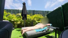 Nude guy lay on a sunlounger