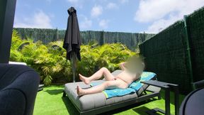 Nude guy lay on a sunlounger