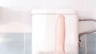 Busty Stepsister riding her dildo in the bathroom