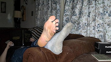 I chill on the living room couch with my feet propped up