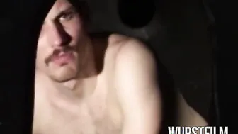 Hairy leather man sucks big cock in gloryhole booth before getting jerked off