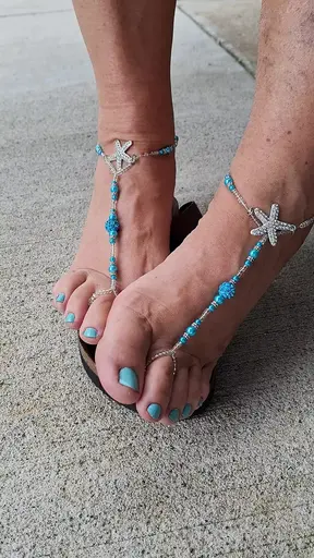Cute, pedicured feet with matching barefoot sandals