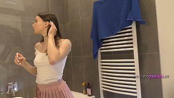 Braless hot brunette skinny and horny babe in a pink mini skirt to show her beautiful ass and legs in the bathroom