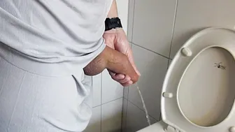 Uncut mature man stretches long foreskin while peeing then shoots massive cumshot