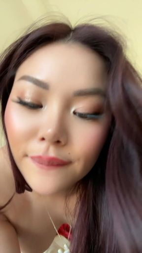 Asian woman with long hair and red lipstick