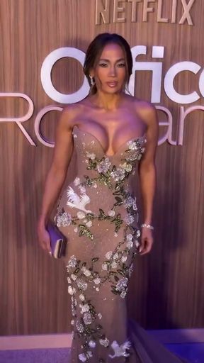 Crossdressed Jen Lopez shows off her cleavage in a dress
