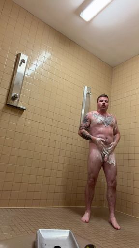 Uncut tattoo jock showering after gym
