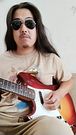 Relaxed hands brush lips while guitar ignites deepthroat dreams
