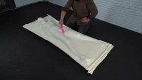 A unique white latex vacuum bed inside which is Sonya receiving powerful orgasms from a vibrator