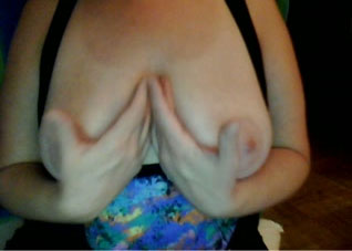 Playing with my impressive natural tits in front of a webcam