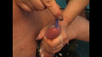 Mistress inserting toothrbush in a guy's cock while she jerks and makes him cum