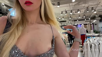 Adorable lady in a sexy dress flashes boobs in a public store.