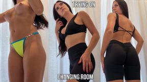 Trying on tight shorts and top in a changing room