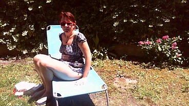 Italian girl sunbathing in a public garden with a big dirty diaper