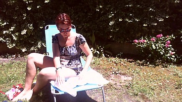 Italian girl sunbathing in a public garden with a big dirty diaper