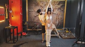 White-clad, booted female heroine humiliated