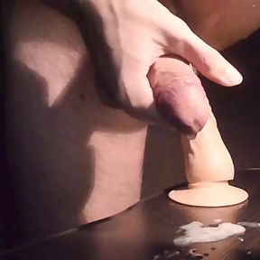 Dildo ride on the table finished with cumshot