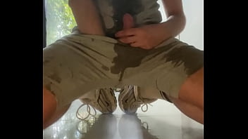 Amateur boy wets himself on the kitchen floor