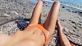 Sunbathing by the shore, strangers nearby as we enjoy the heat