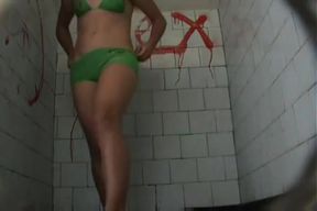 A brunette model goes to the pool bathroom to take a huge