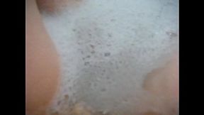 Sultry copper-haired milf Annie gets comfy in the bath, fingering her cooch