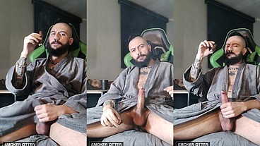 Tattoed daddy smoking a cigar in his smoky robes